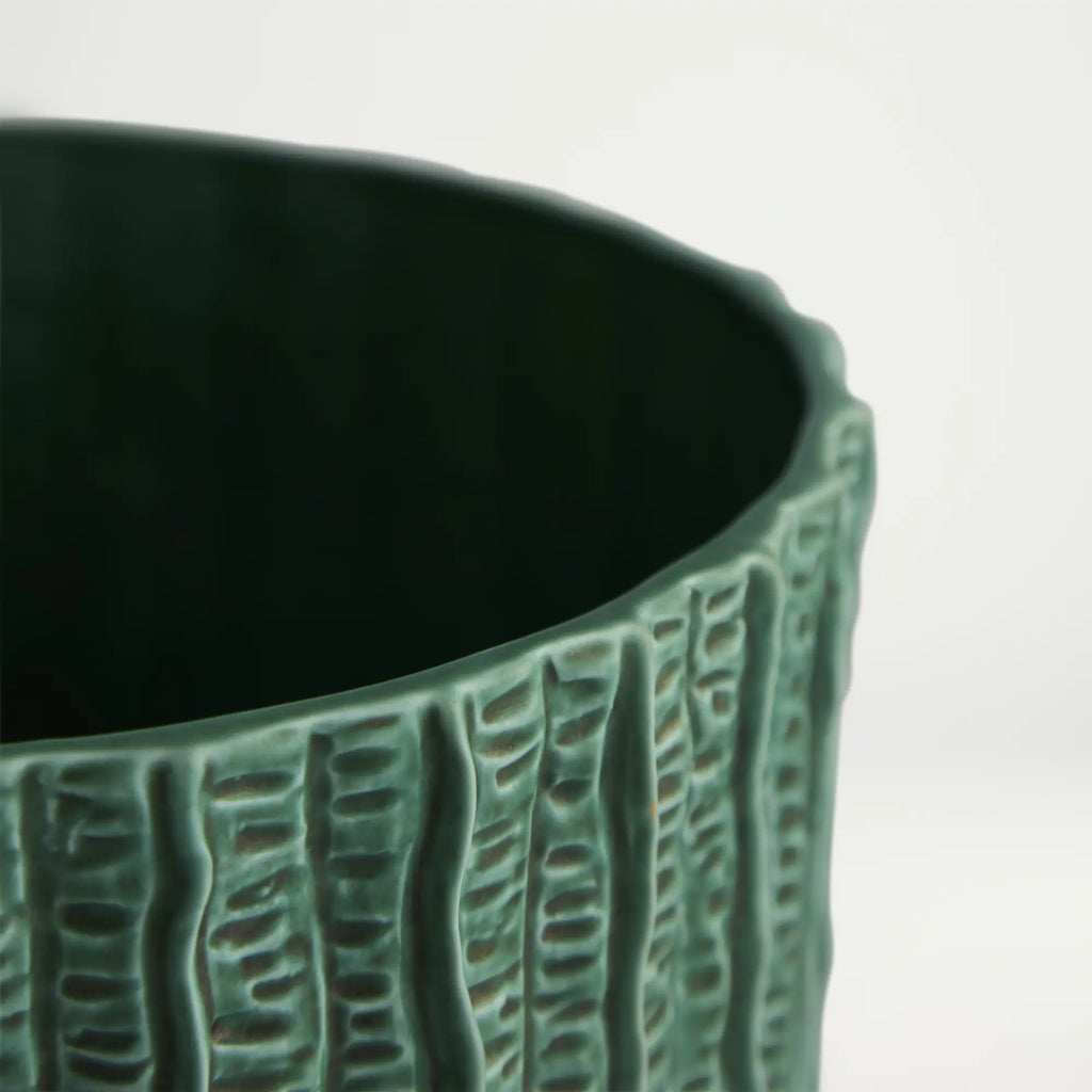 Green textured ceramic planter on a light gray background